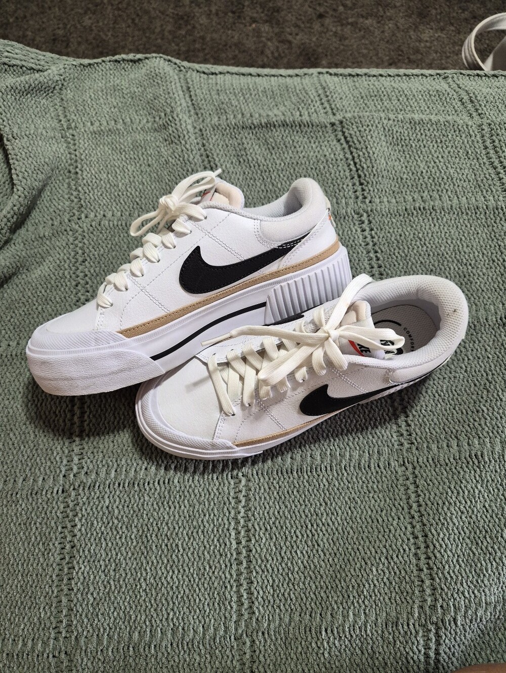 Nike Platform Court White Sneakers with Black Swoosh and Tan Accent.